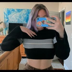 Soft, cropped sweater with black, white and gray stripes.